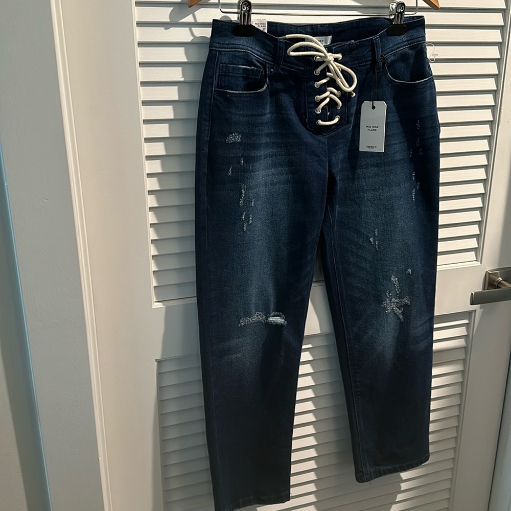 NWT Forever 21 Mid Rise Flare Jeans with string closure and five pockets.Size 27